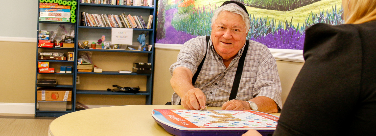 Older Gentleman Playing Scrabble at Signature Senior Living